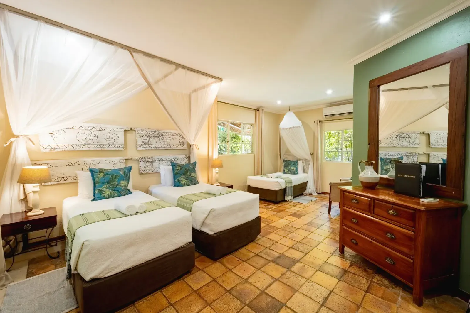 Twin room at Bayete Guest Lodge with beds under mosquito nets