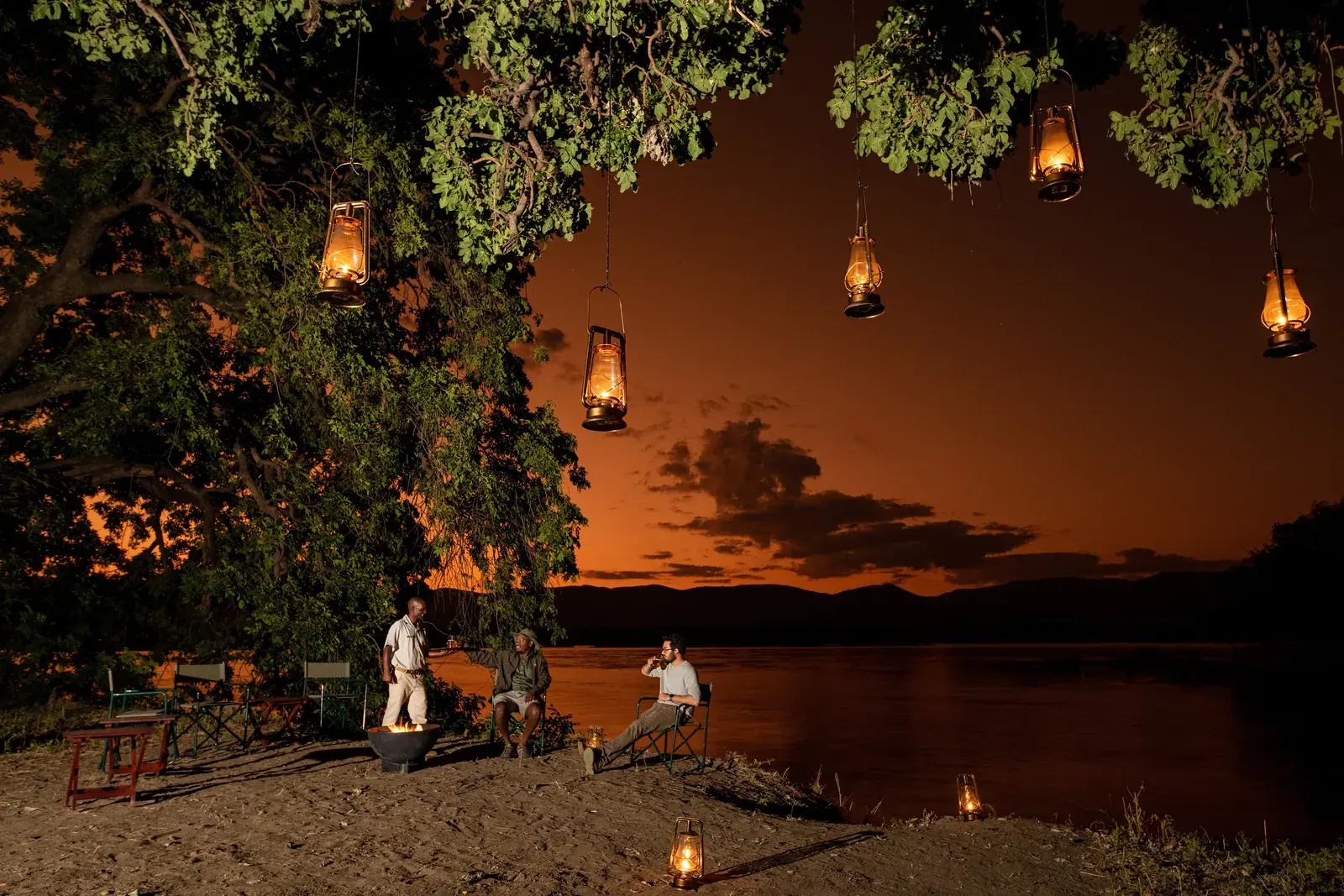 Lanterns in the trees beside the Zambezi at Mana River Camp