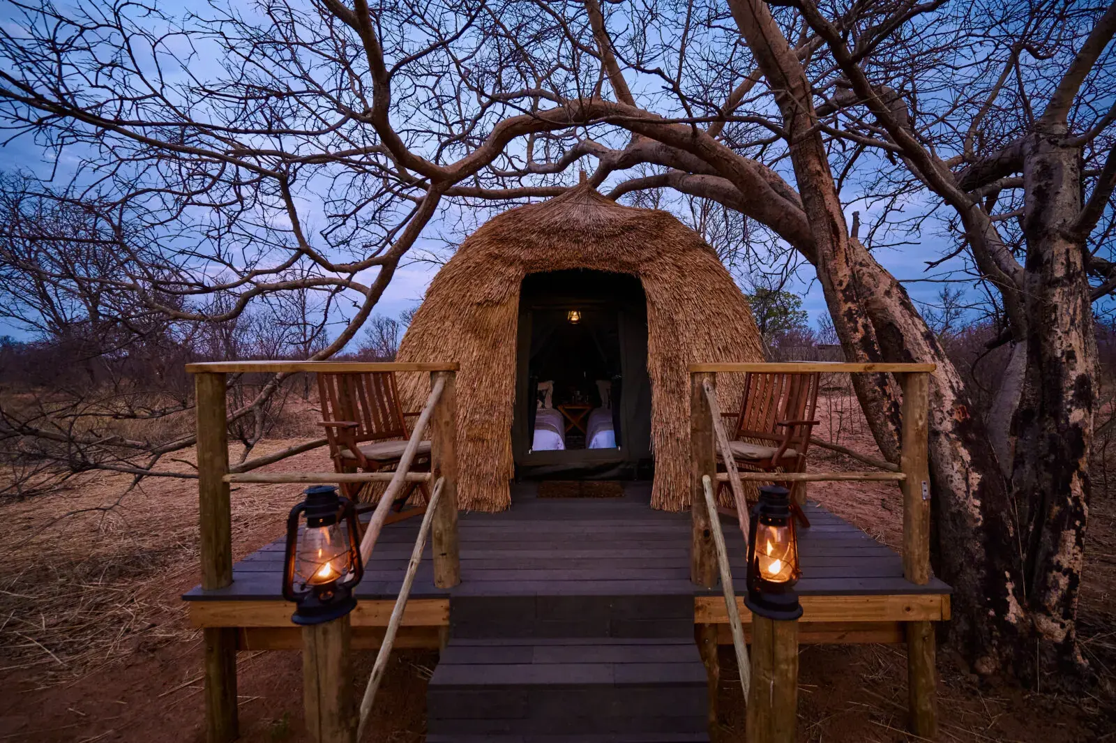 Lantern-lit shelter at night at Nxamaseri Island Lodge