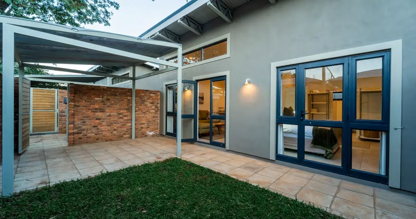 Walled courtyard and garden outside a pod at The Pods, Victoria Falls