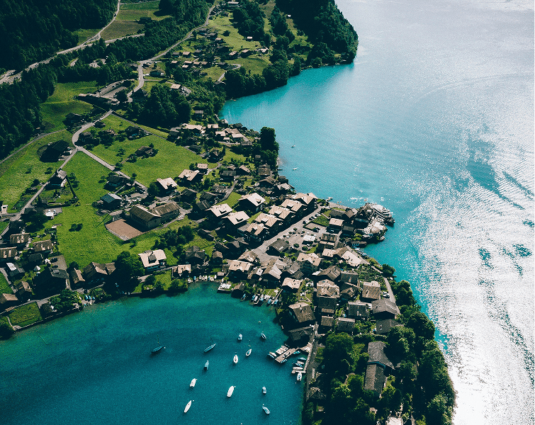 Aerial view of a village beside turquoise water
